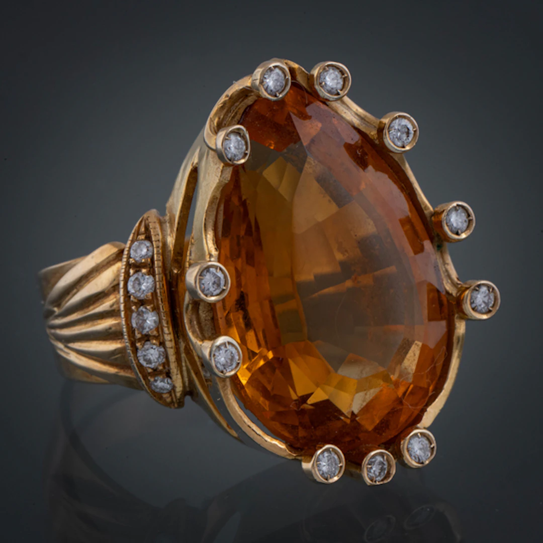 Anillo en oro amarillo de 18kt con topacio talla pera y brillantes.