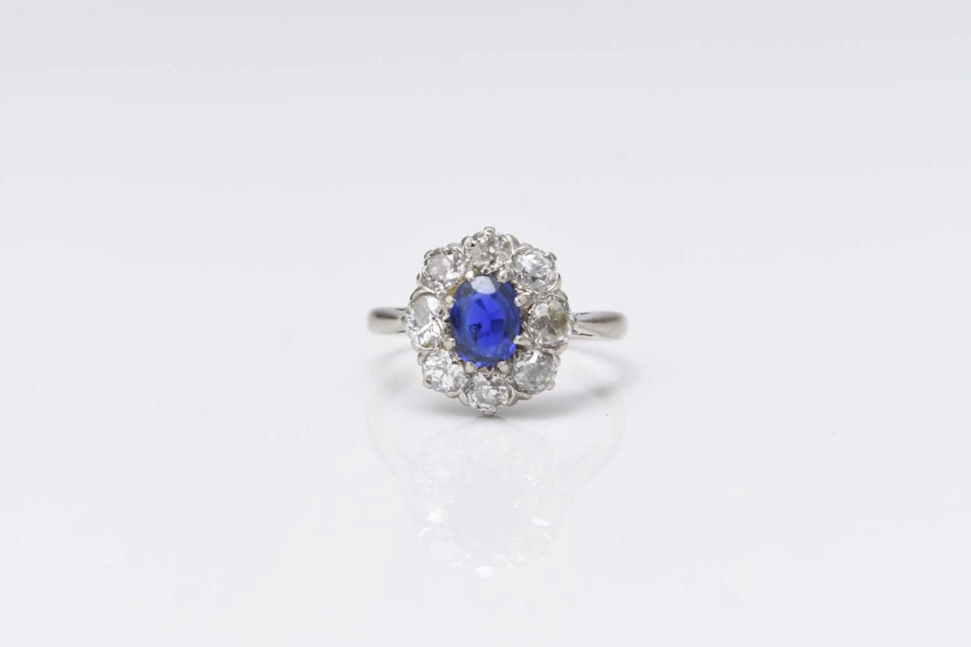 An early-mid 20th century old cut diamond and sapphire oval cluster ring