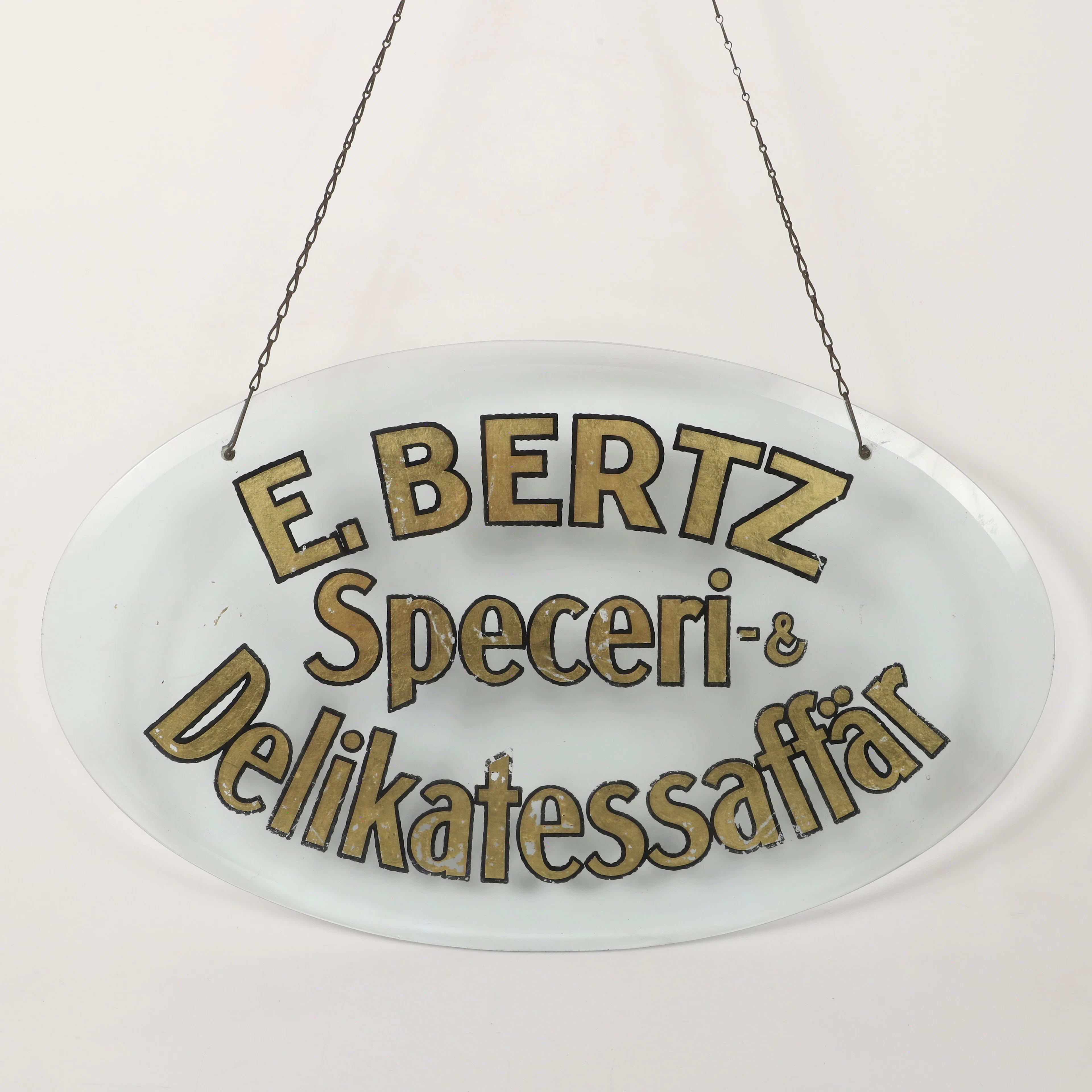 AFFÄRSSKYLT, målat glas, E. Bertz Speceri-& Delikatessaffär.