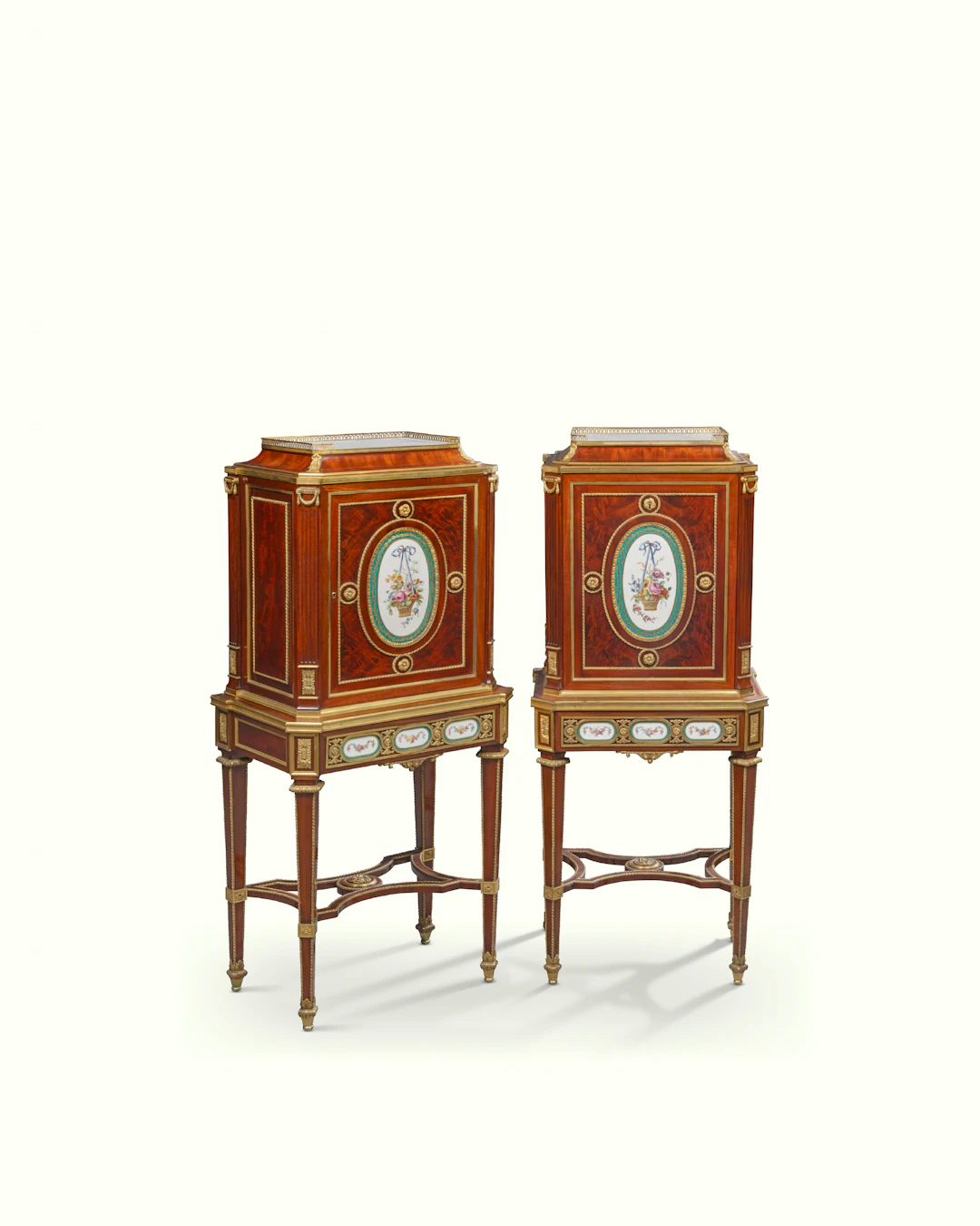 A PAIR OF FRENCH ORMOLU AND PORCELAIN-MOUNTED MAHOGANY CABINETS-ON-STAND