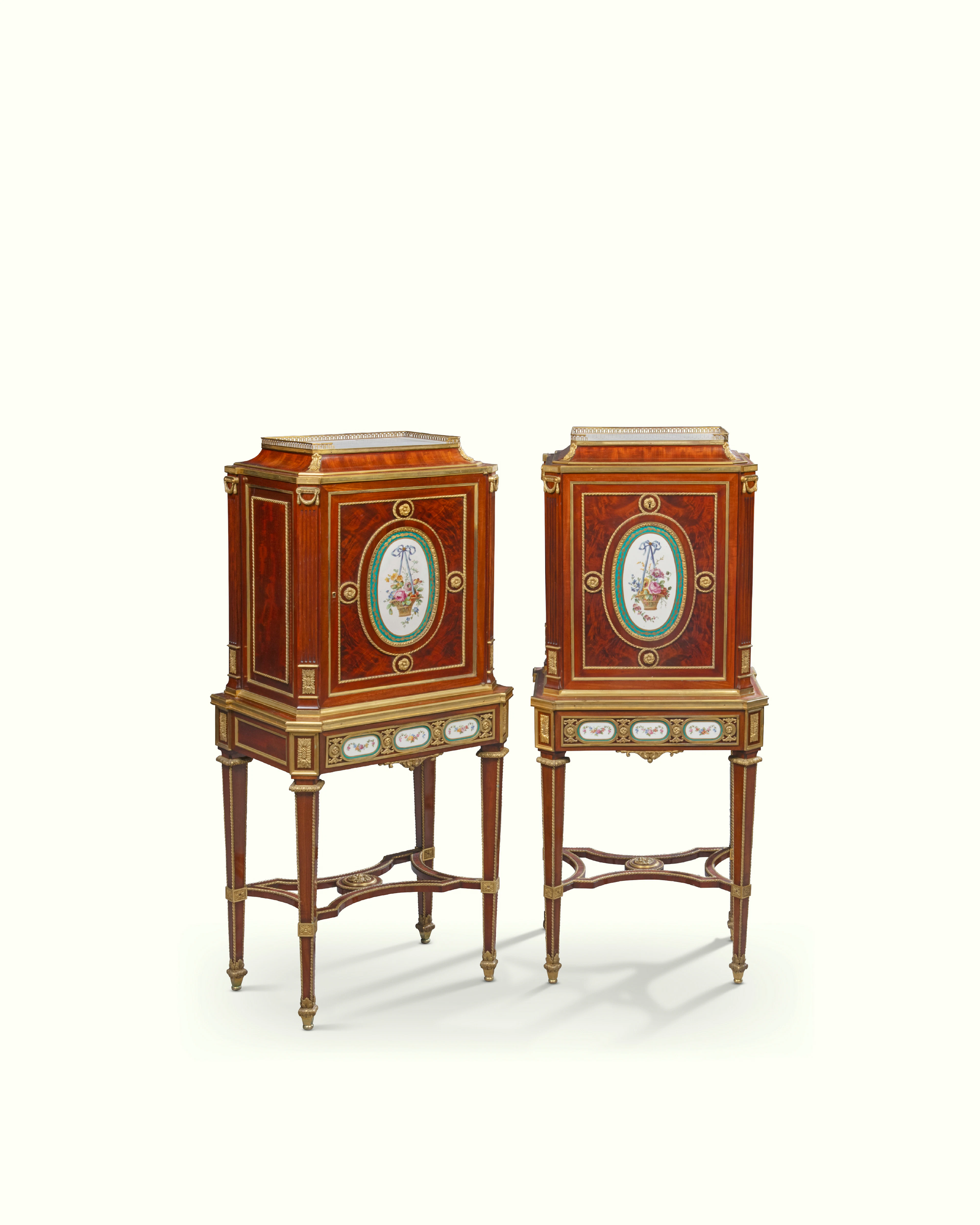 A PAIR OF FRENCH ORMOLU AND PORCELAIN-MOUNTED MAHOGANY CABINETS-ON-STAND