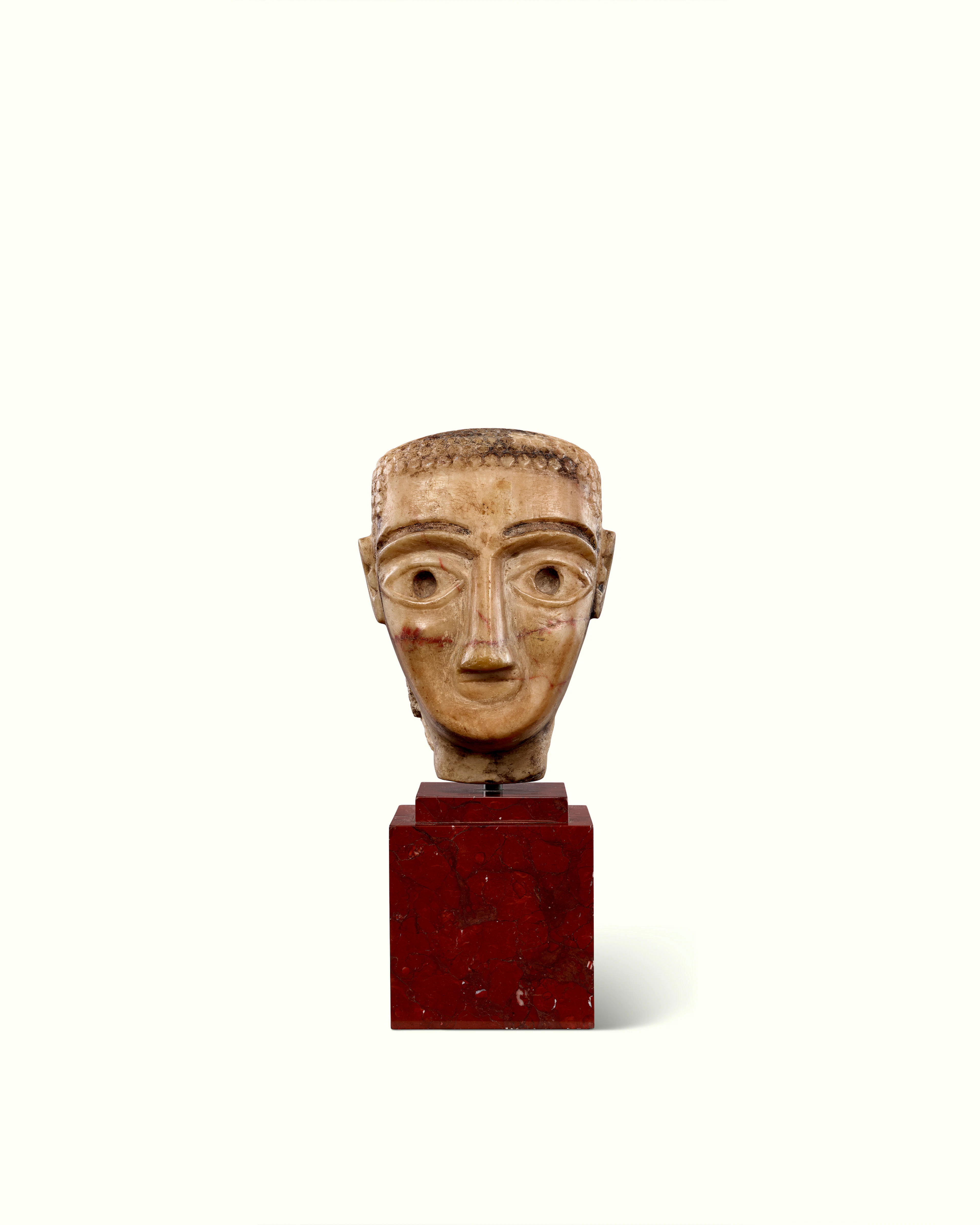 A SOUTH ARABIAN ALABASTER PORTRAIT HEAD OF A MAN