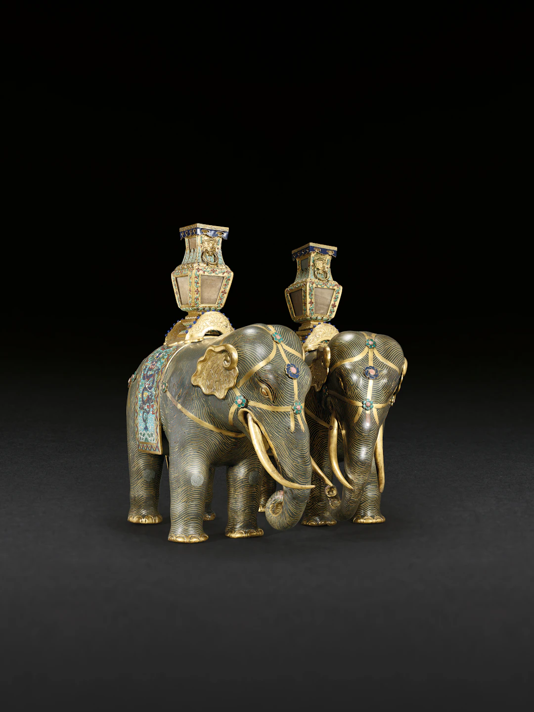 A MAGNIFICENT PAIR OF CLOISONNÉ ENAMEL FIGURES OF CAPARISONED ELEPHANTS