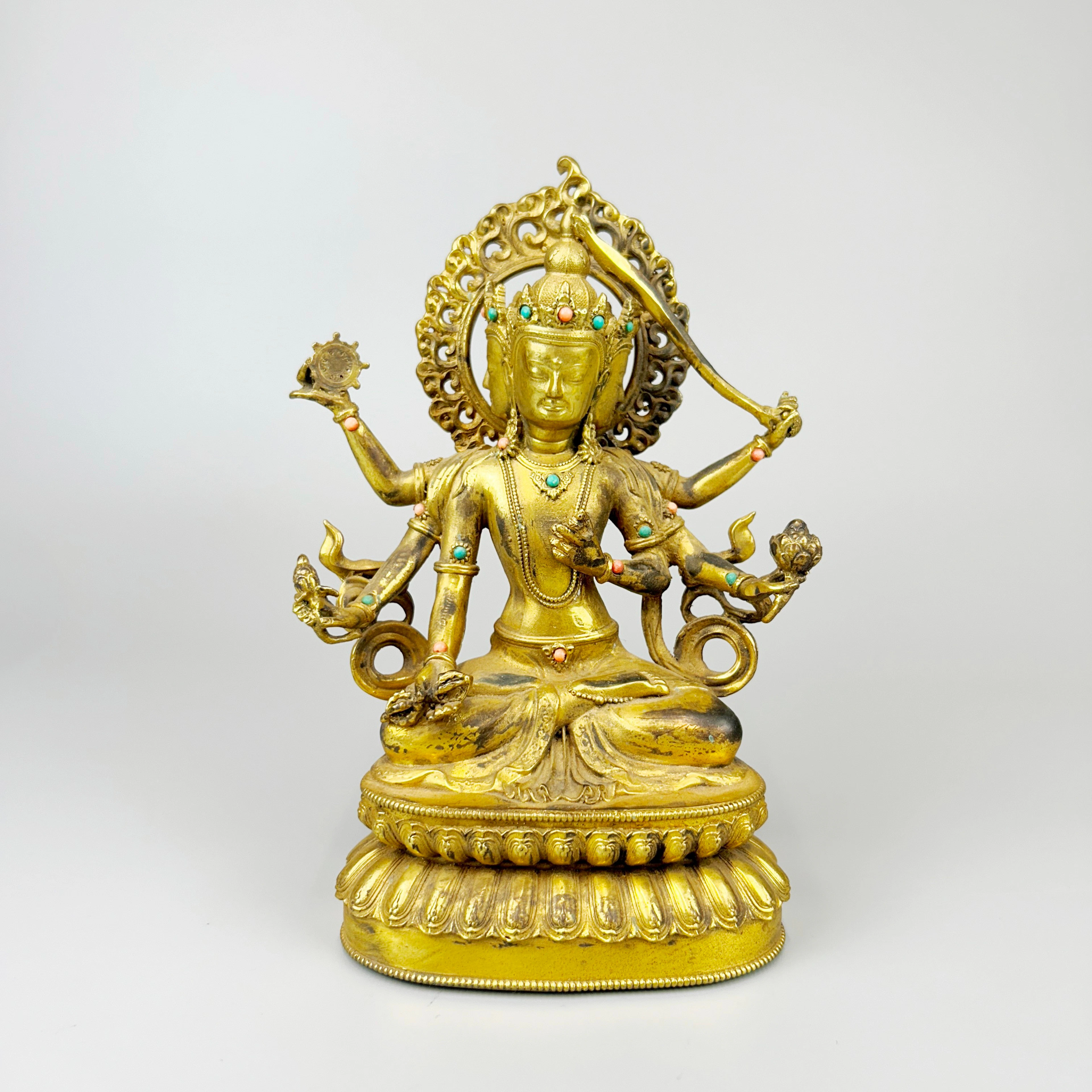 TIBETAN GILT BRONZE DEITY.