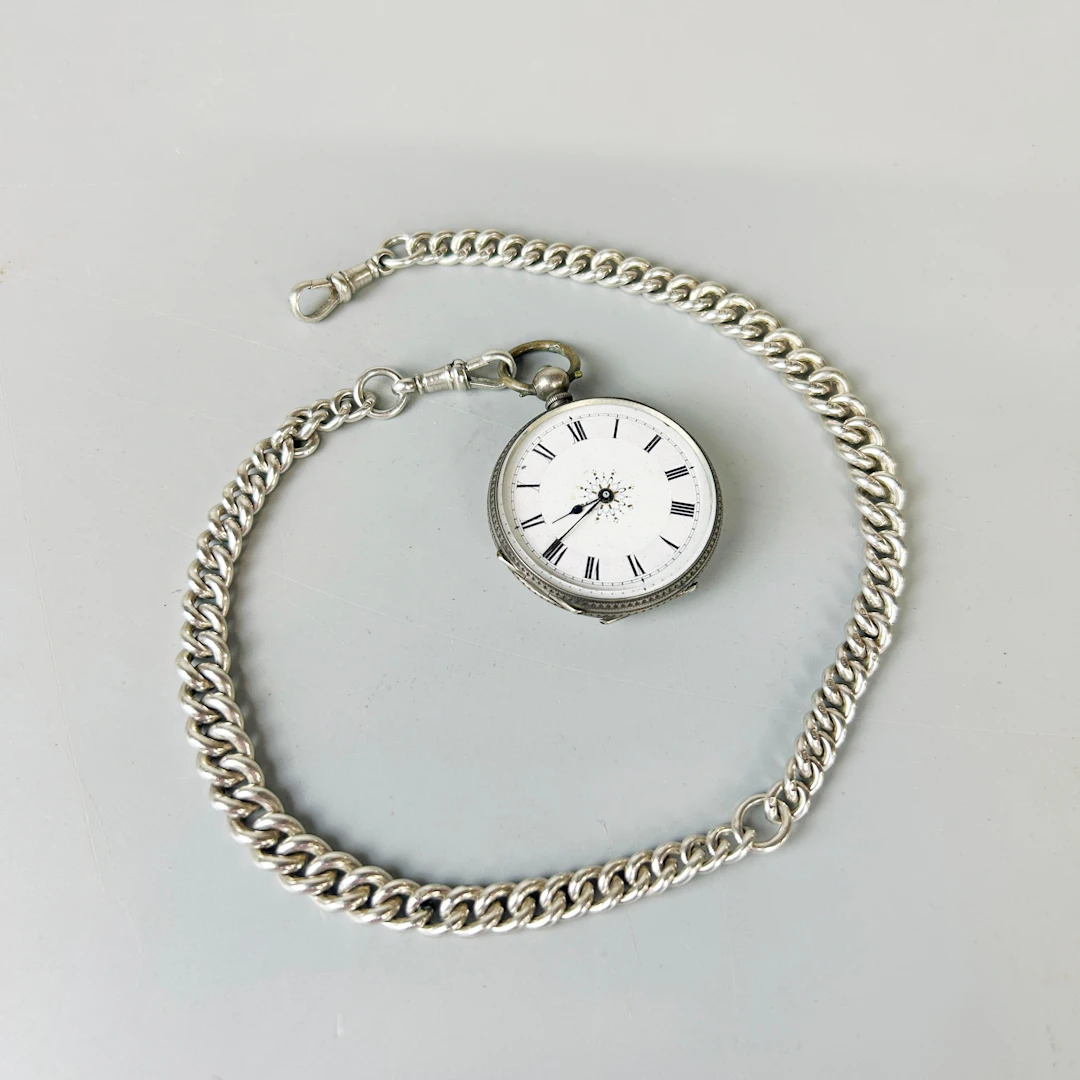 SILVER POCKET WATCH AND CHAIN.