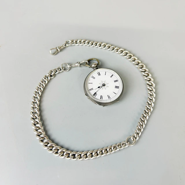 SILVER POCKET WATCH AND CHAIN.