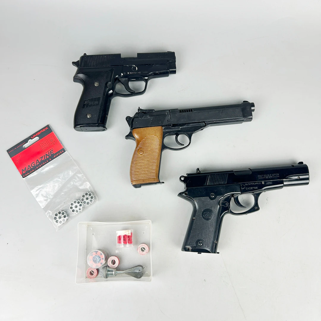 THREE TOY PISTOLS.