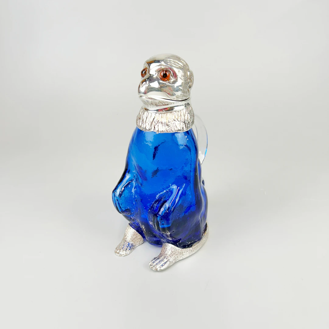 SILVER PLATED & BLUE GLASS MONKEY JUG.