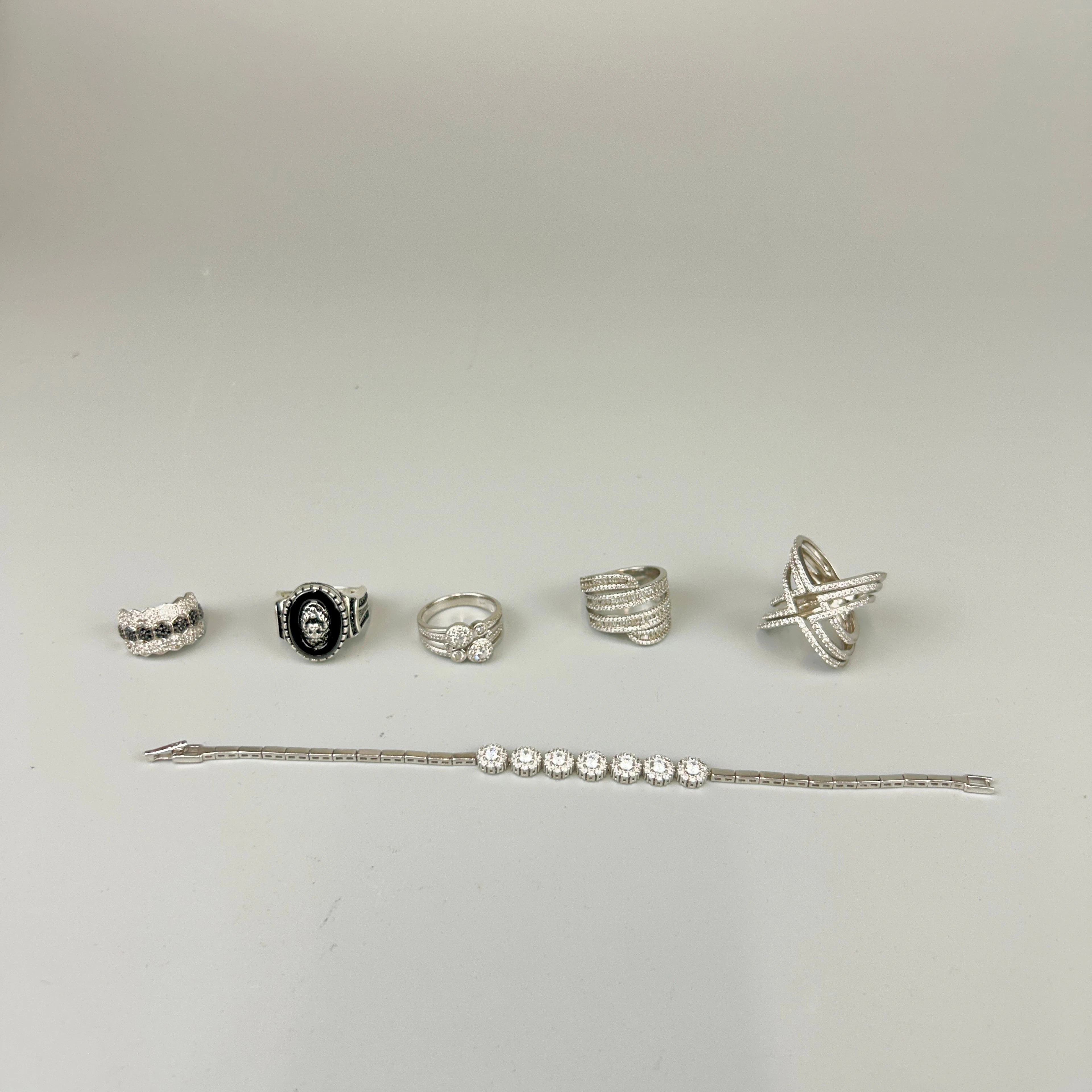 FOUR WHITE STONE SET RINGS ETC.