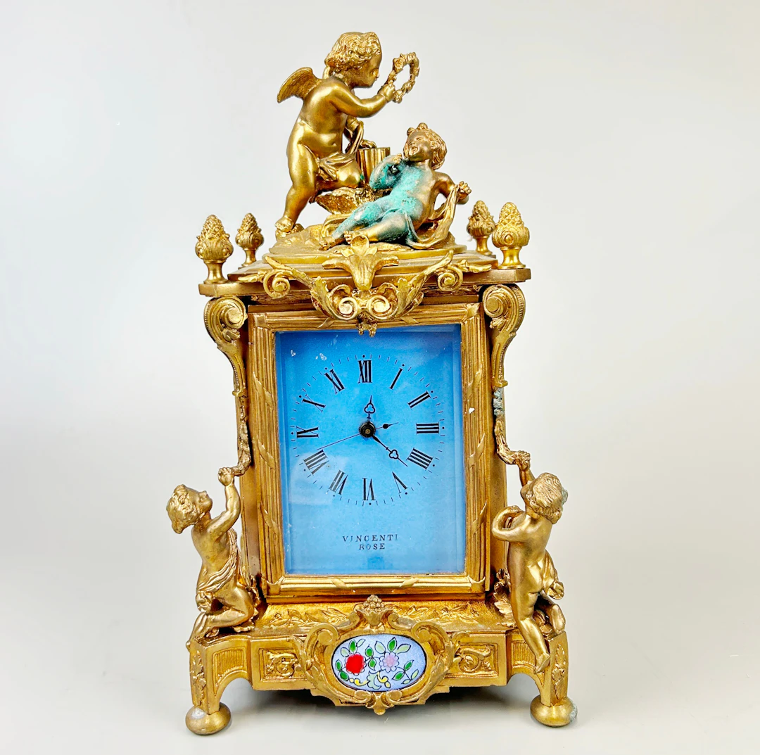 GILT BRONZE CHERUB CARRIAGE CLOCK.