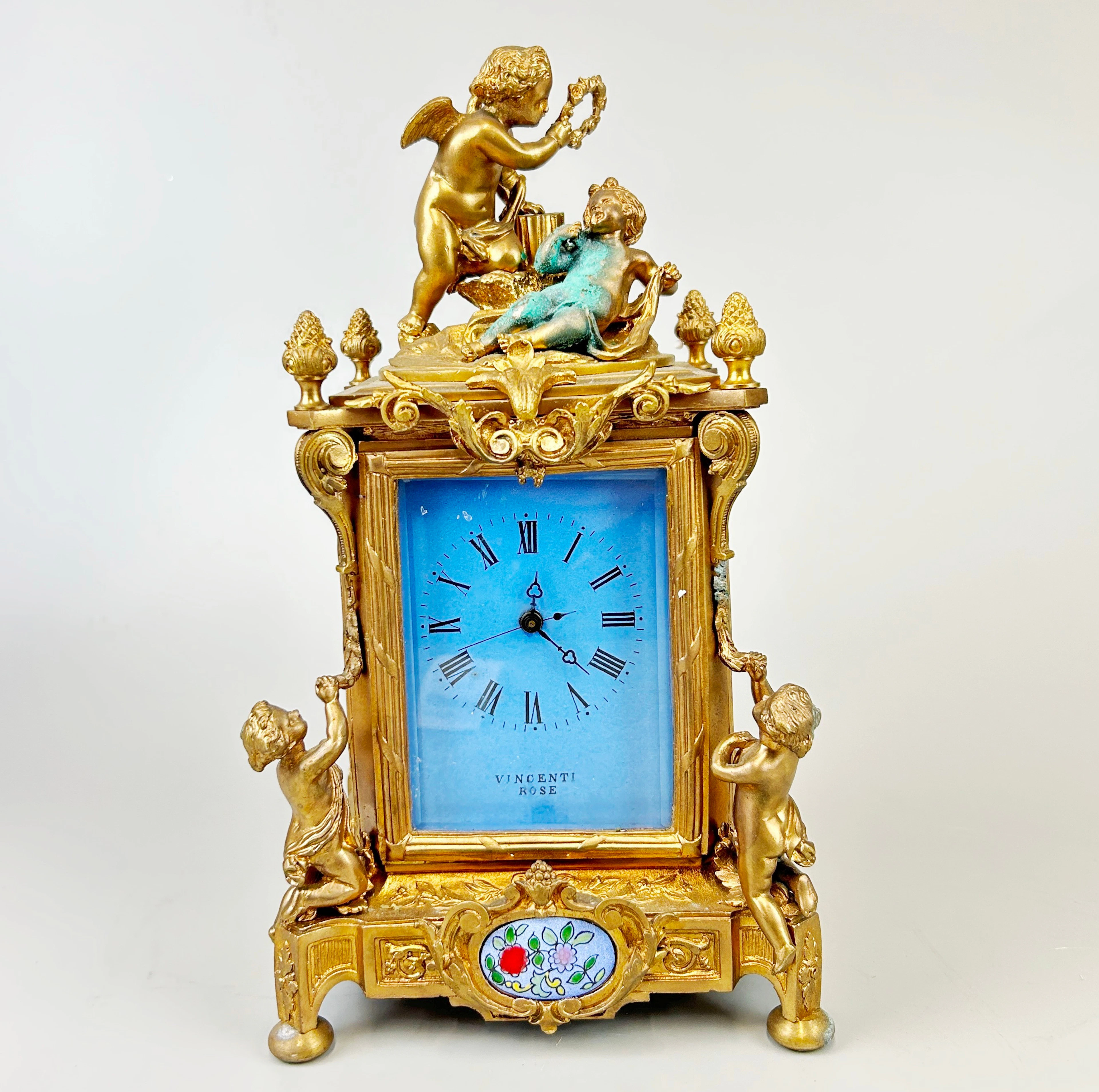 GILT BRONZE CHERUB CARRIAGE CLOCK.