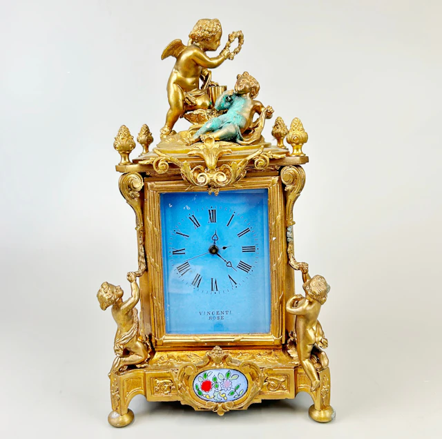 GILT BRONZE CHERUB CARRIAGE CLOCK.