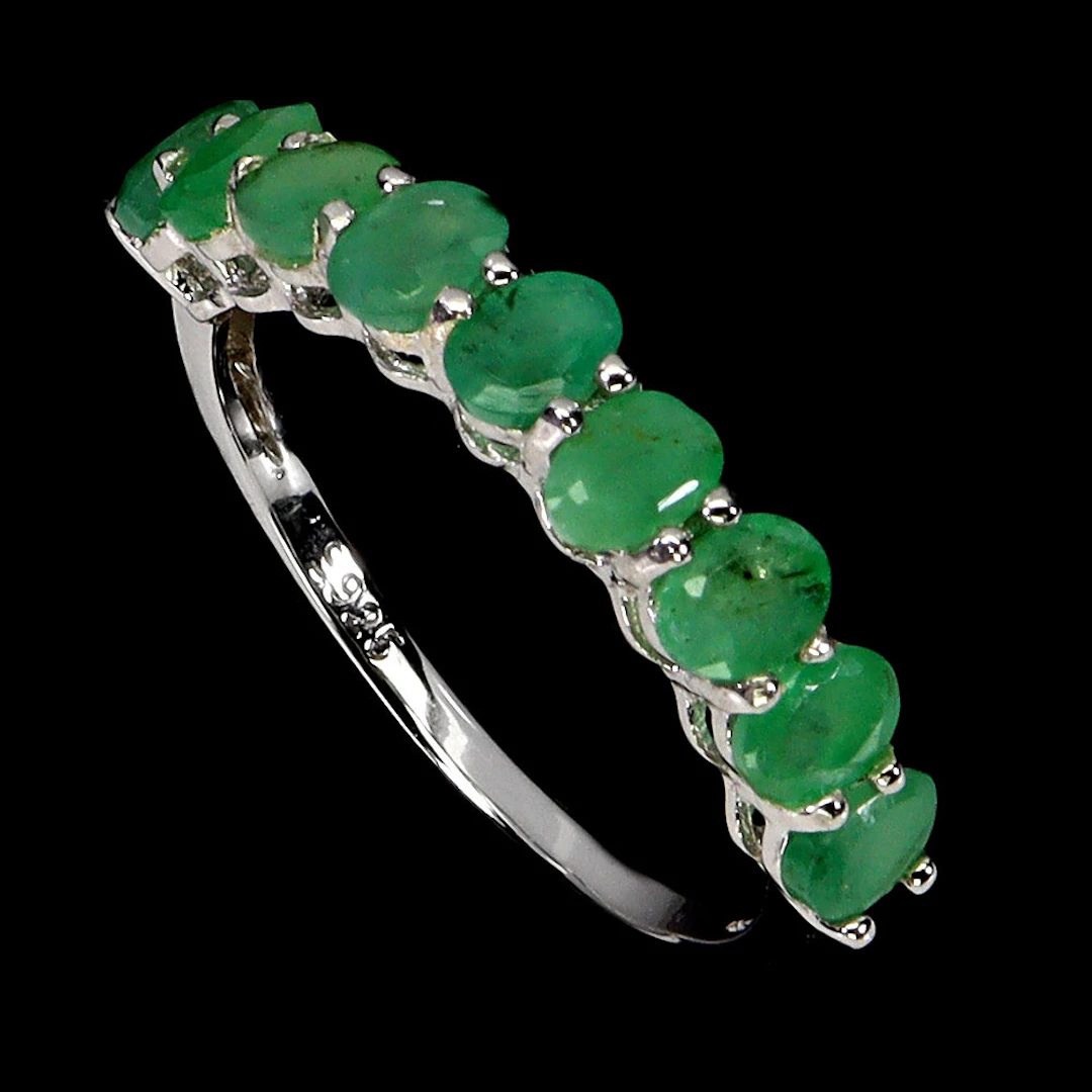 EMERALD SILVER HALF ETERNITY RING.