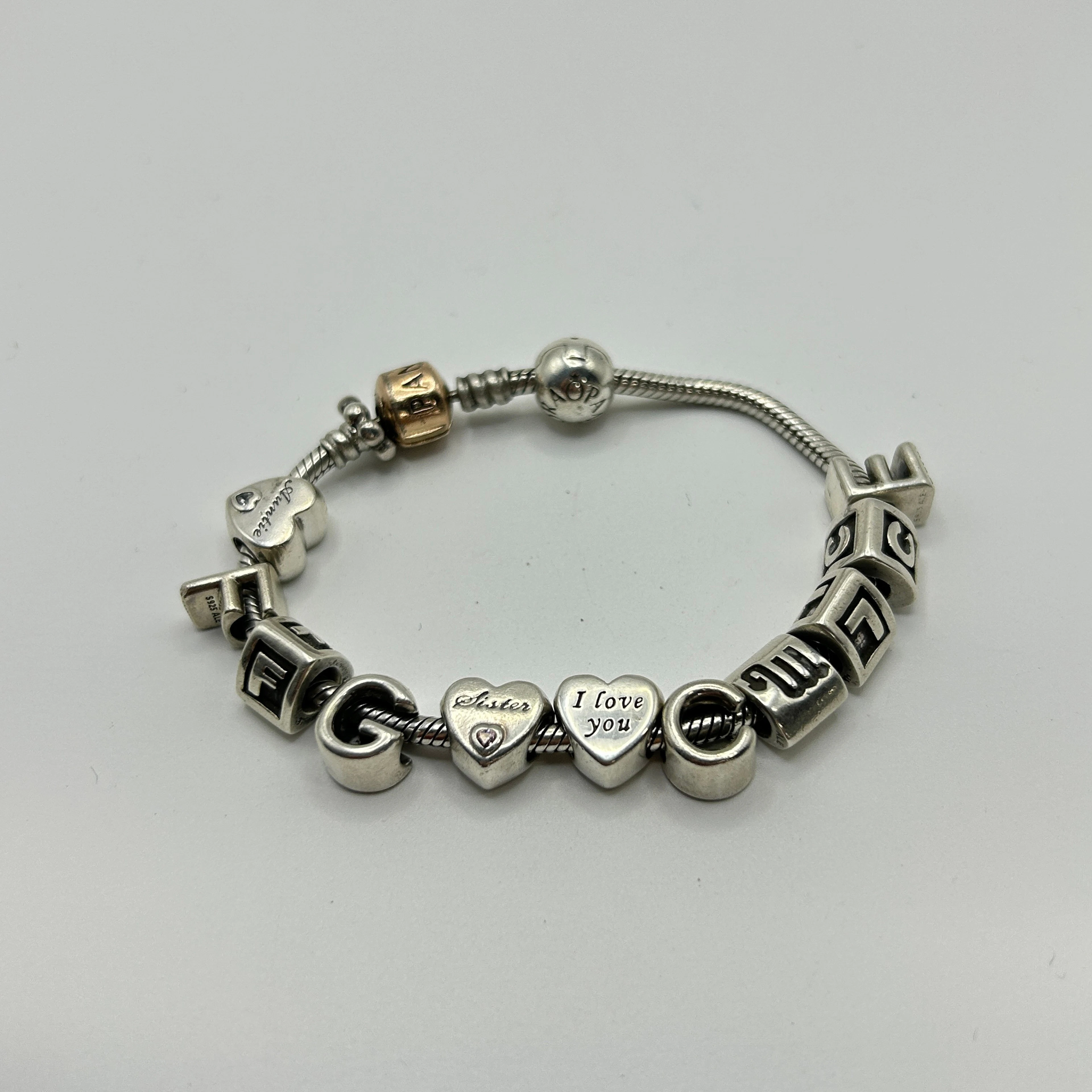 SILVER PANDORA CHARM BRACELET.