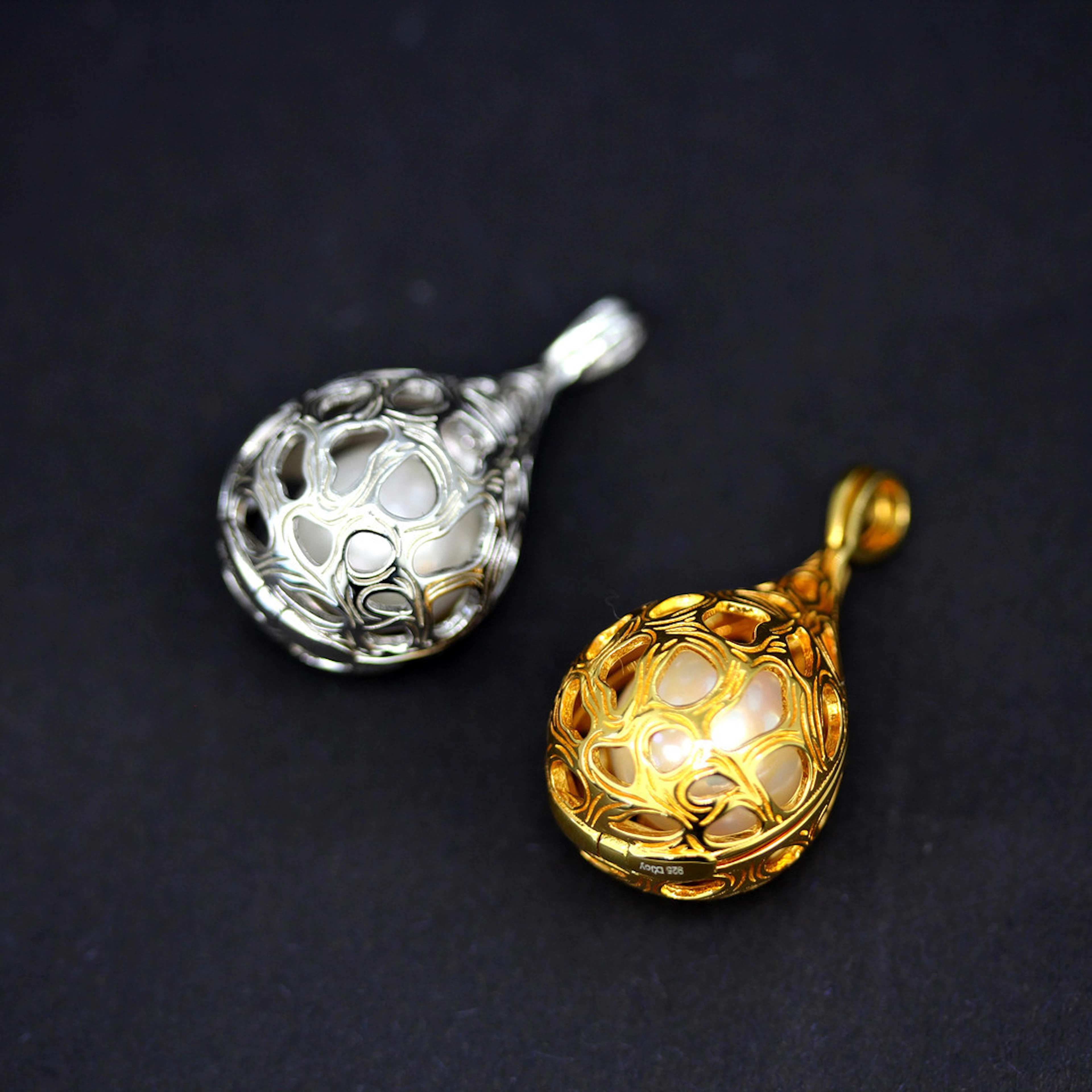 TWO SILVER & GILT PEARL LOCKET PENDANTS.