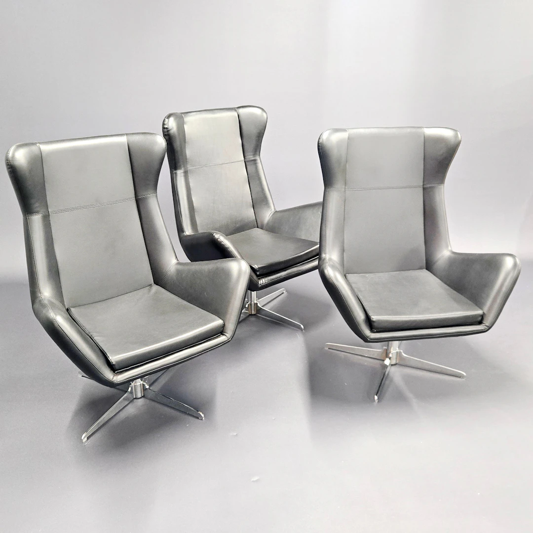 1970'S FAUX LEATHER SWIVEL ARMCHAIRS.