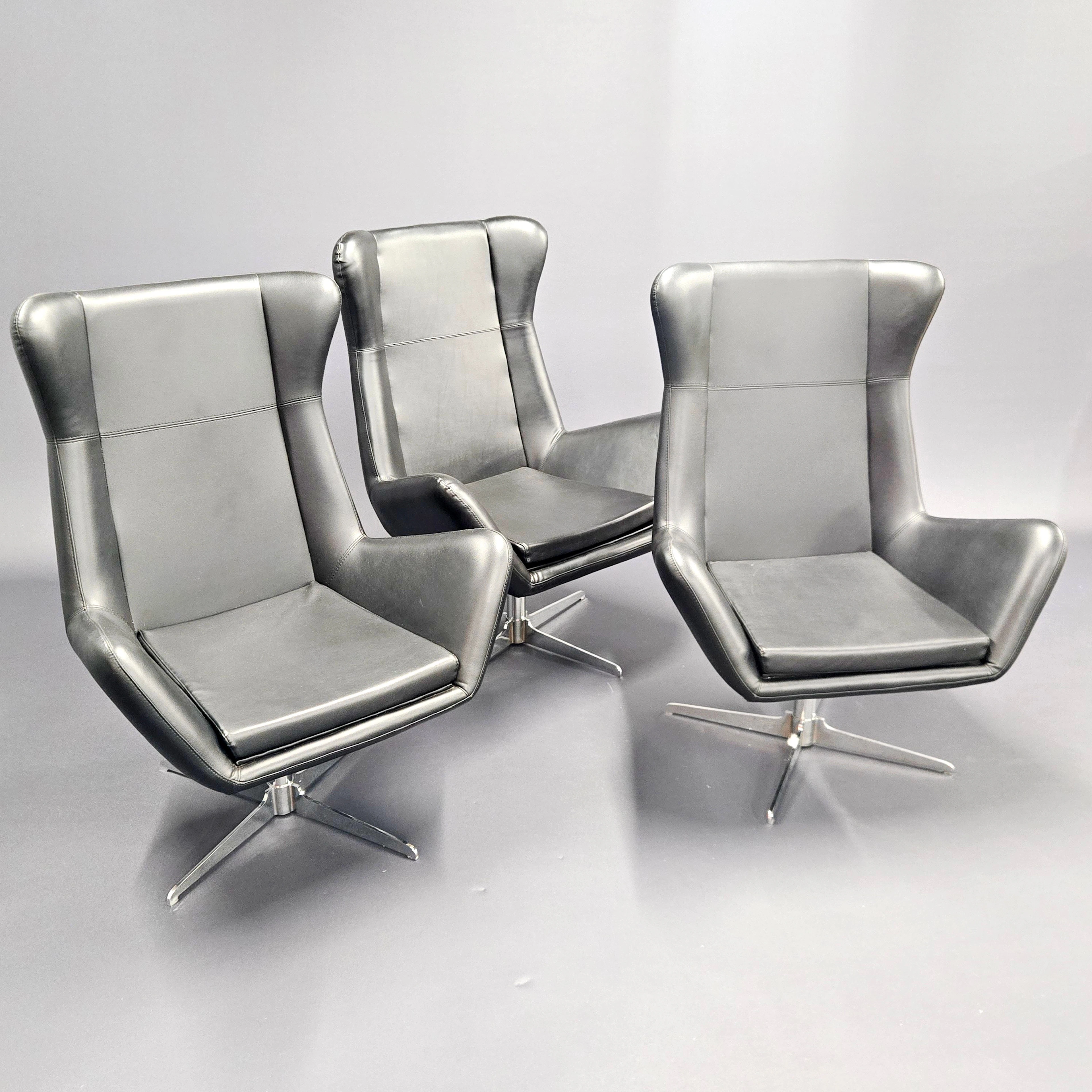 1970'S FAUX LEATHER SWIVEL ARMCHAIRS.