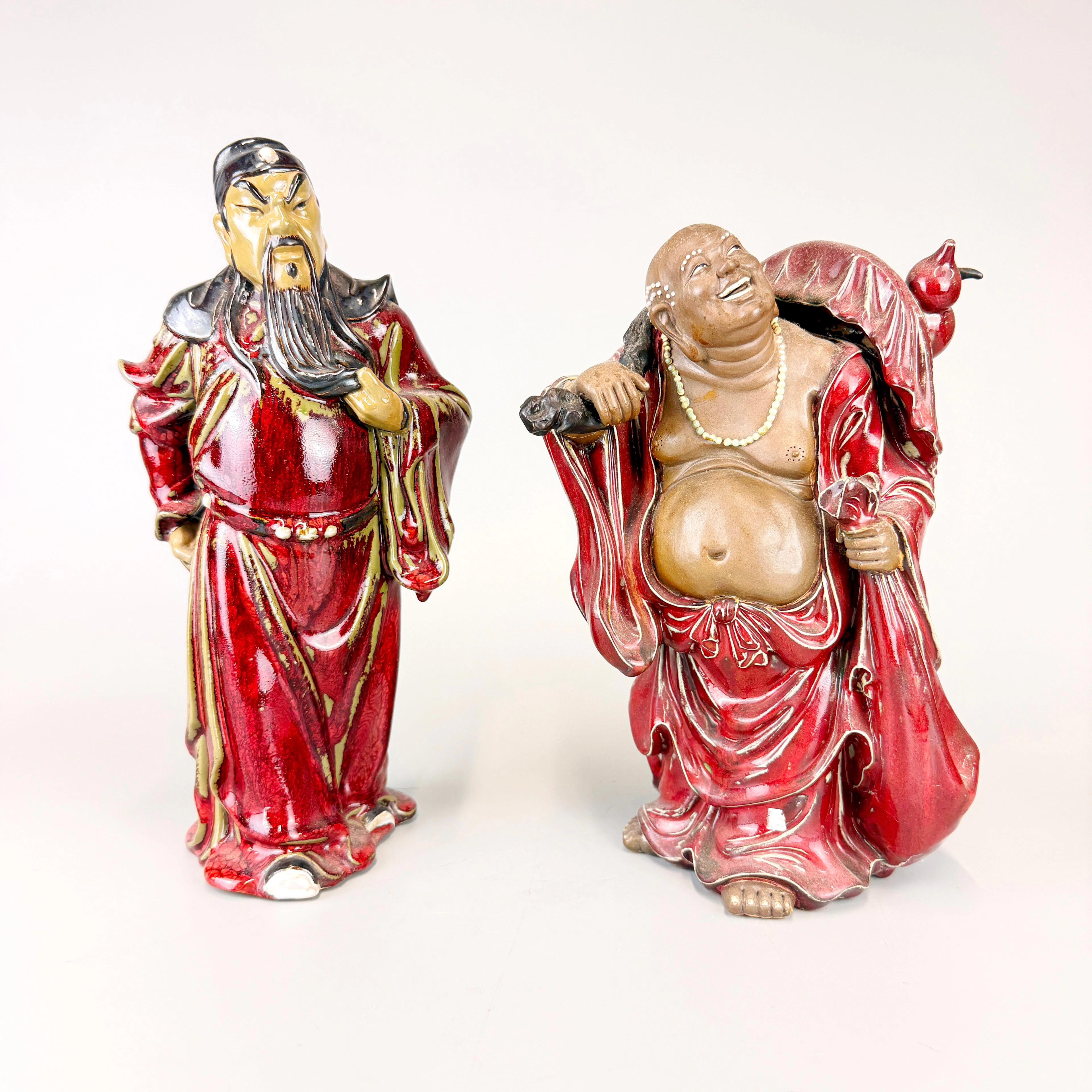 TWO STONEWARE GUARDIAN FIGURES.