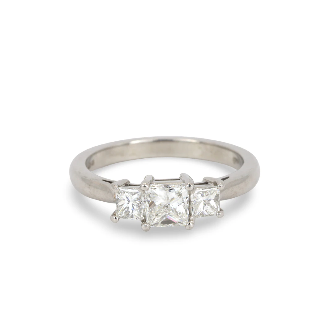 PLATINUM DIAMOND THREE STONE RING.
