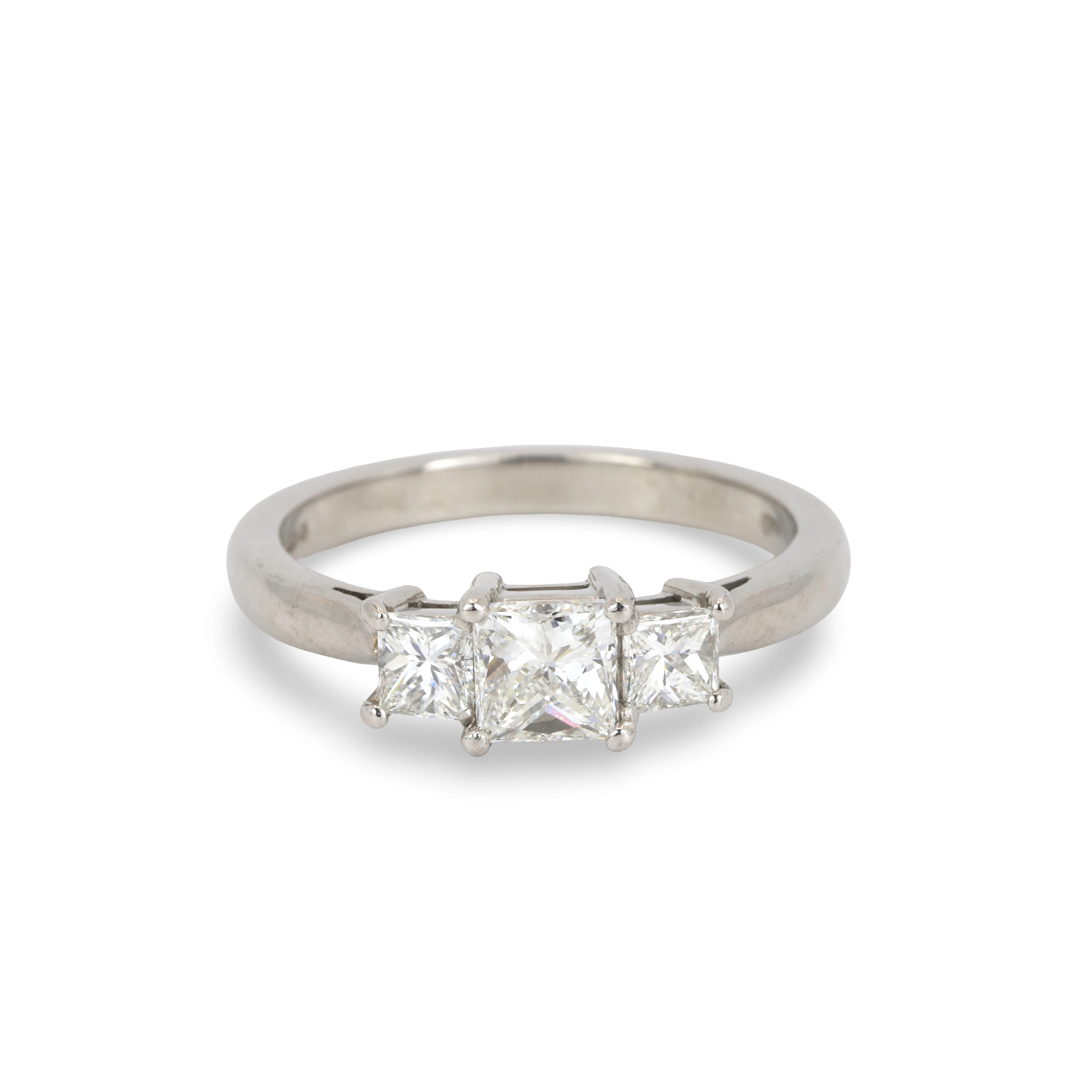 PLATINUM DIAMOND THREE STONE RING.