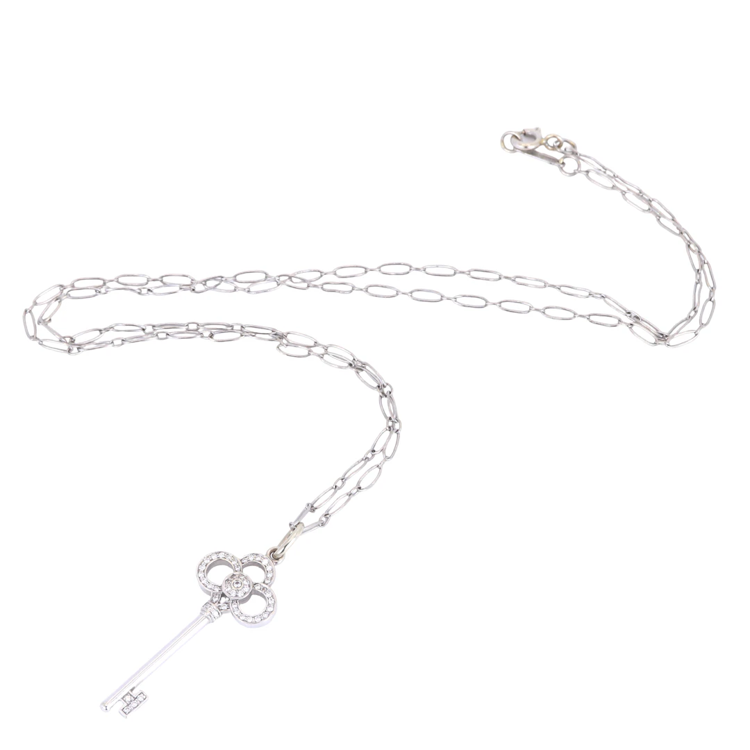 18CT DIAMOND PENDANT & CHAIN.