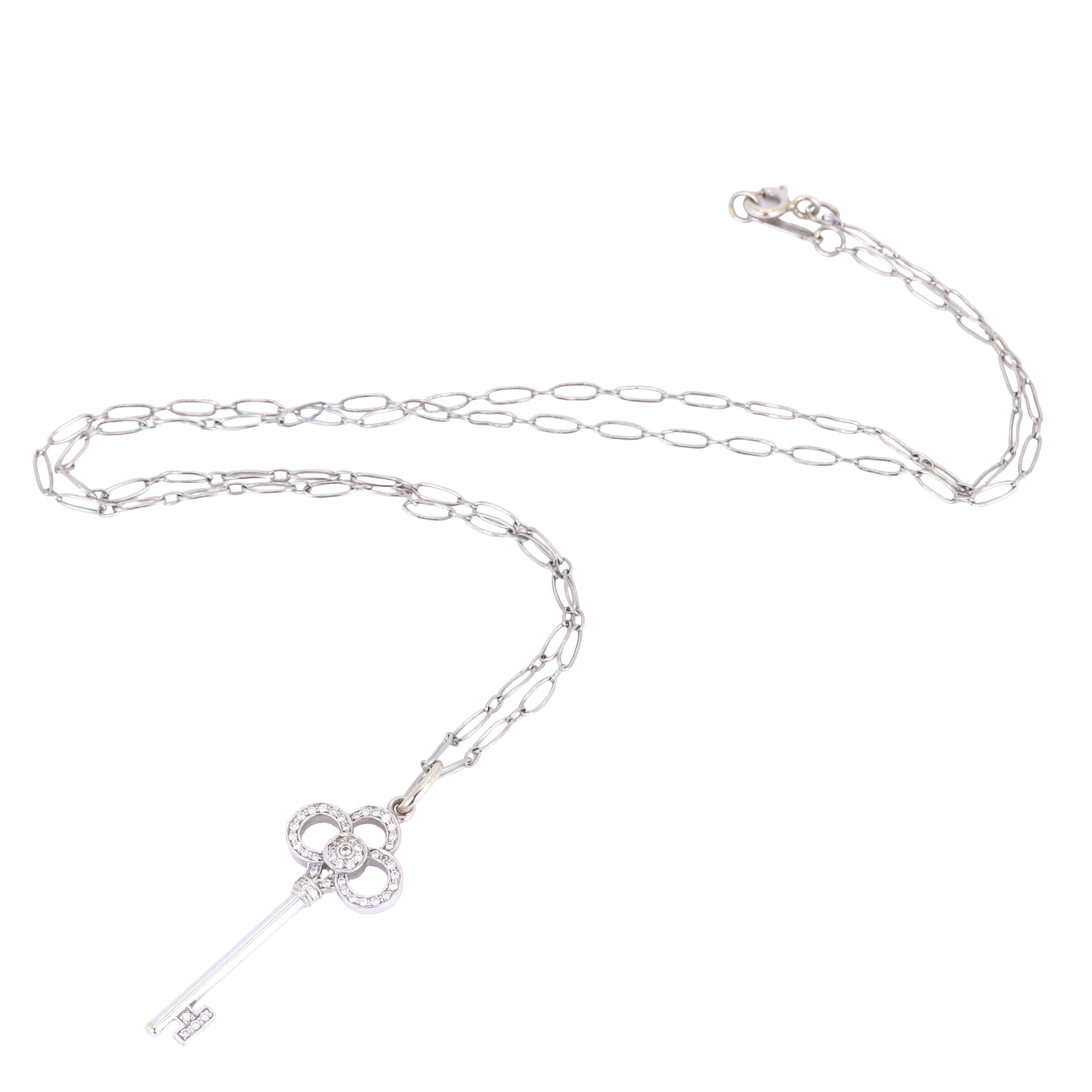 18CT DIAMOND PENDANT & CHAIN.