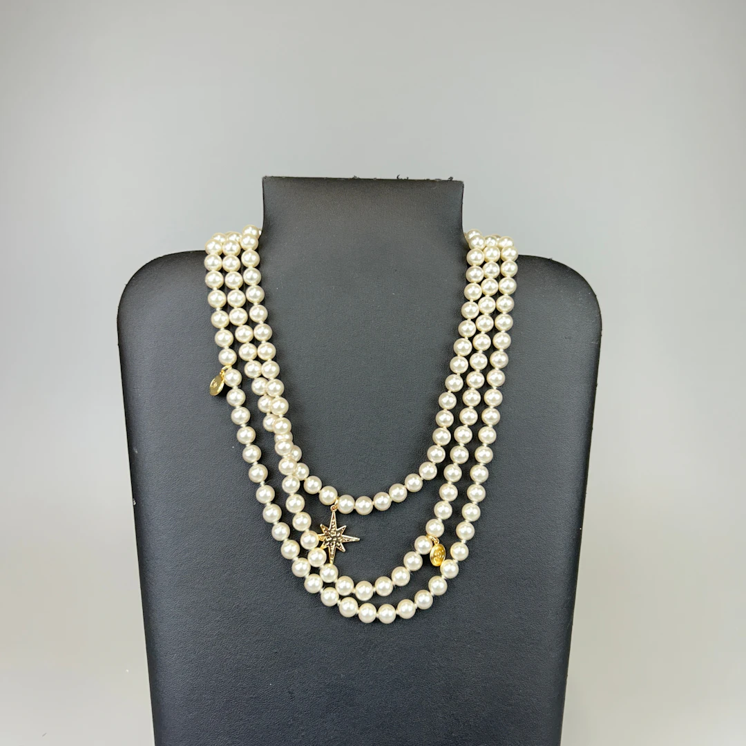 THREE STRAND FAUX PEARL NECKLACE.