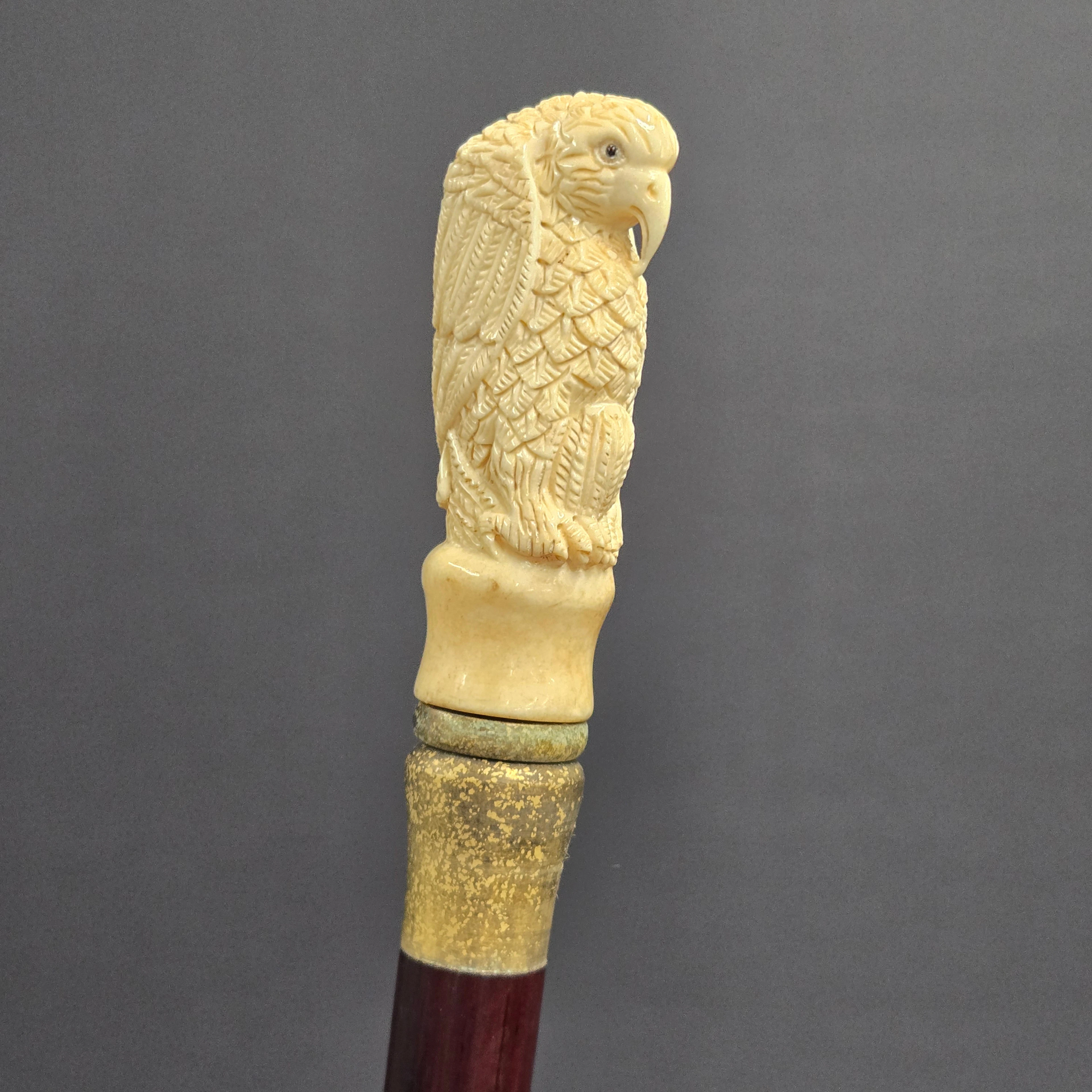CARVED BONE HANDLED WALKING STICK.