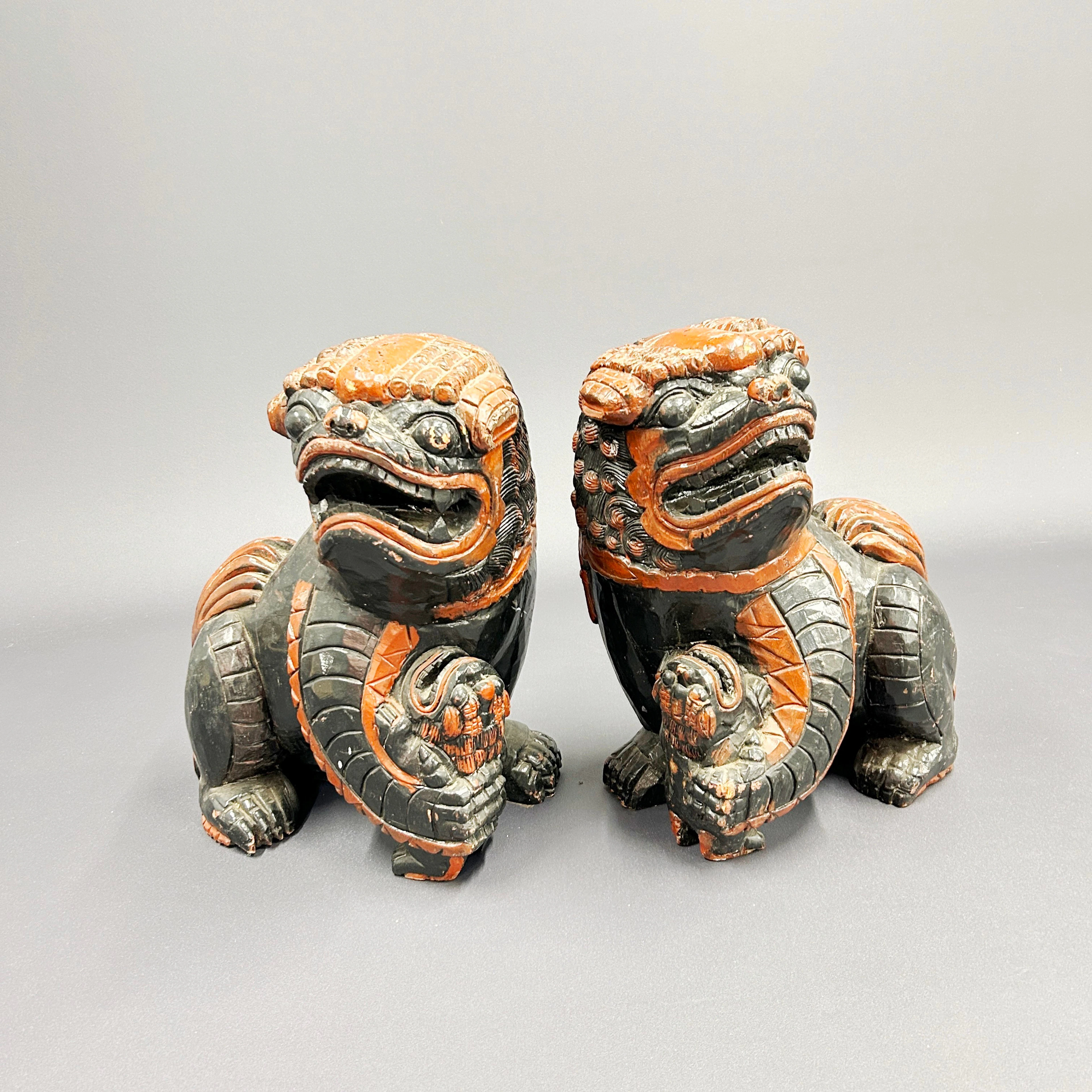 LARGE WOODEN LION DOGS.