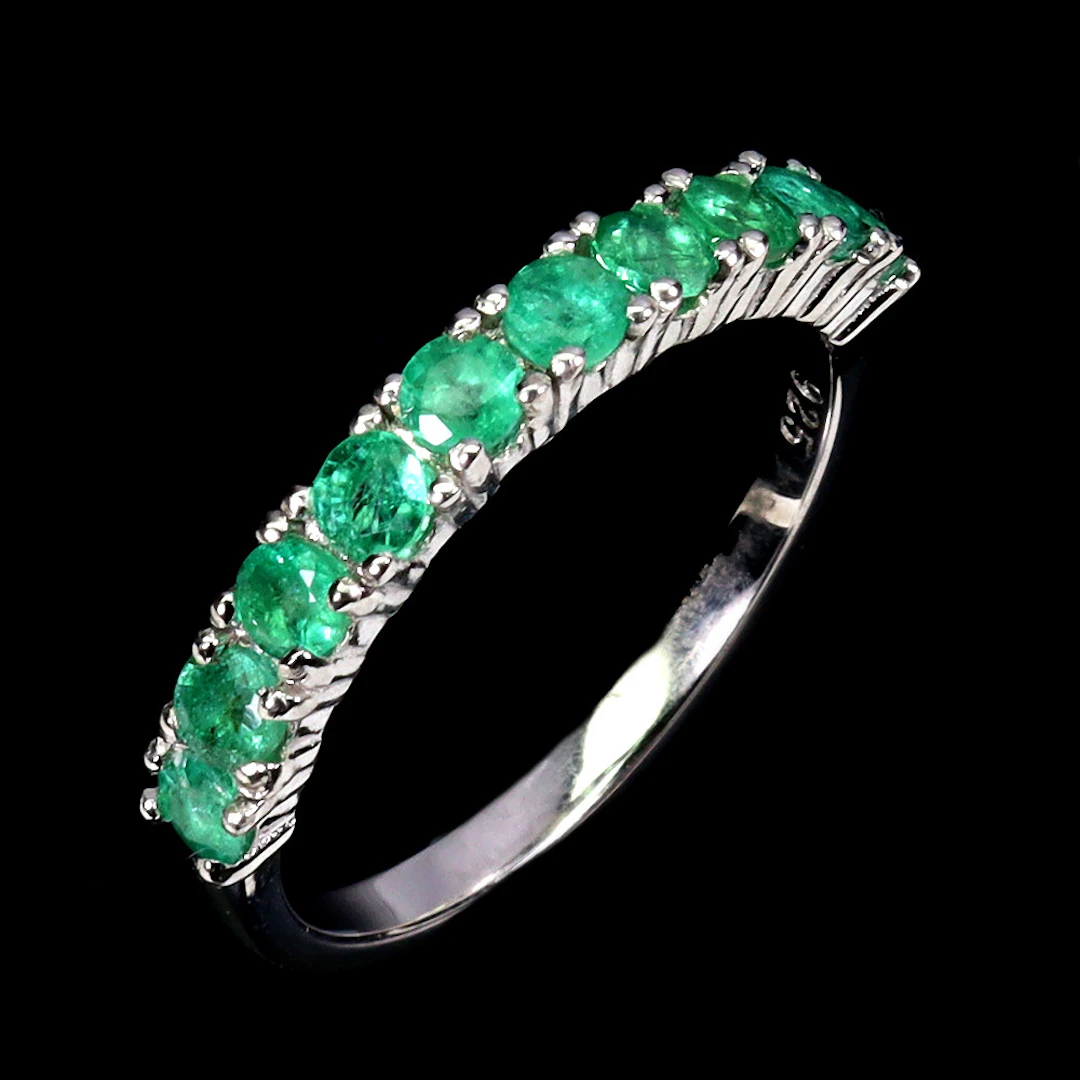 EMERALD SILVER HALF ETERNITY RING.