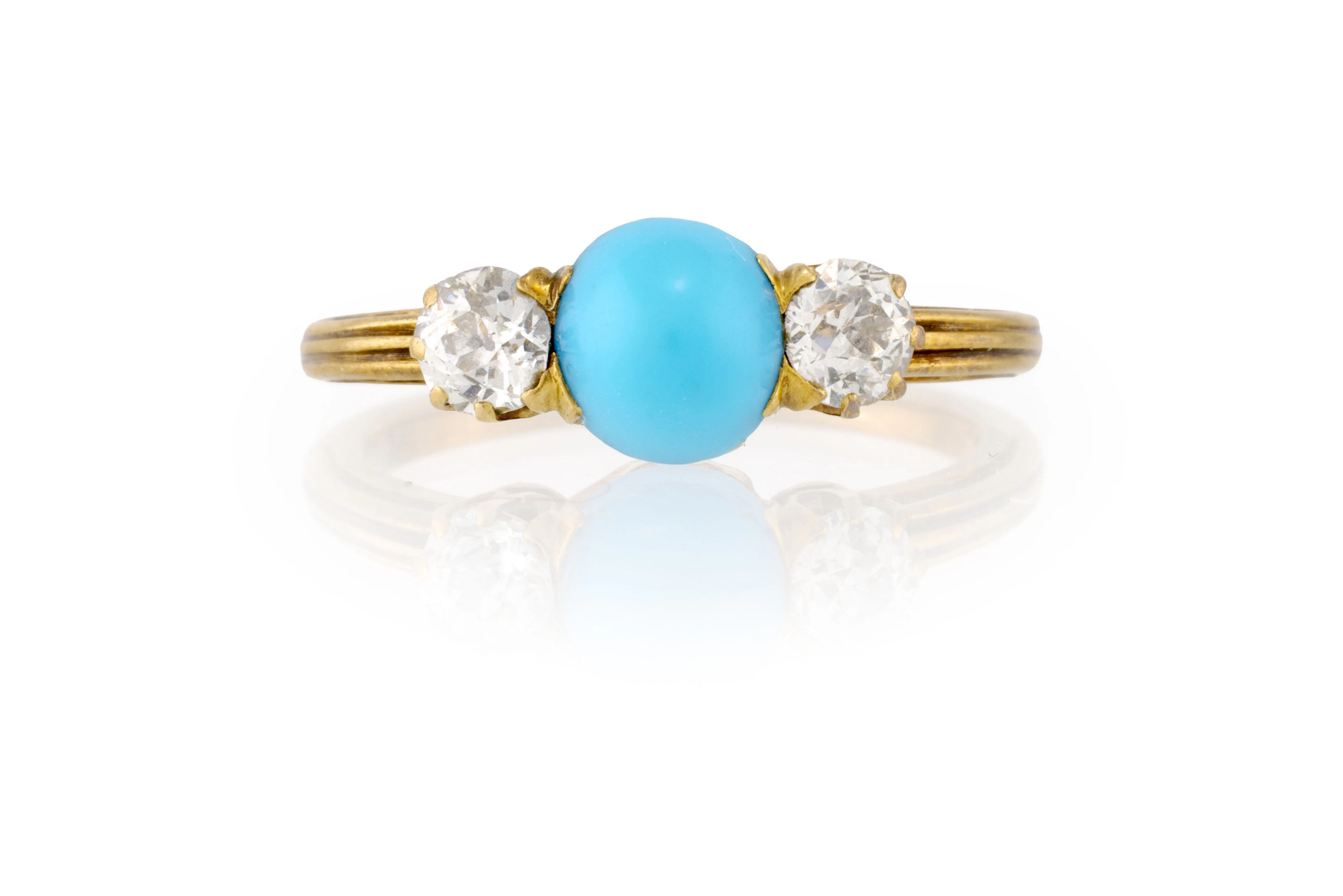 Bague or 750 sertie d'un cabochon de turquoise épaulé de deux diamants