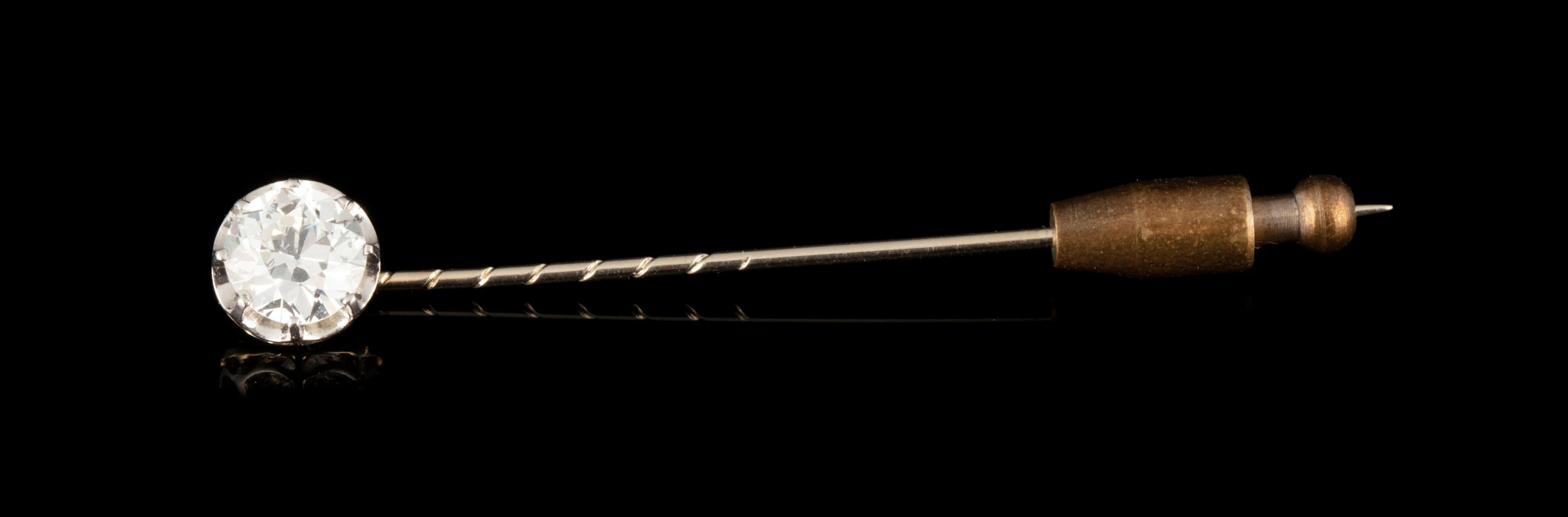 Epingle début XXe s., or gris 750 et platine sertie d'un diamant taille