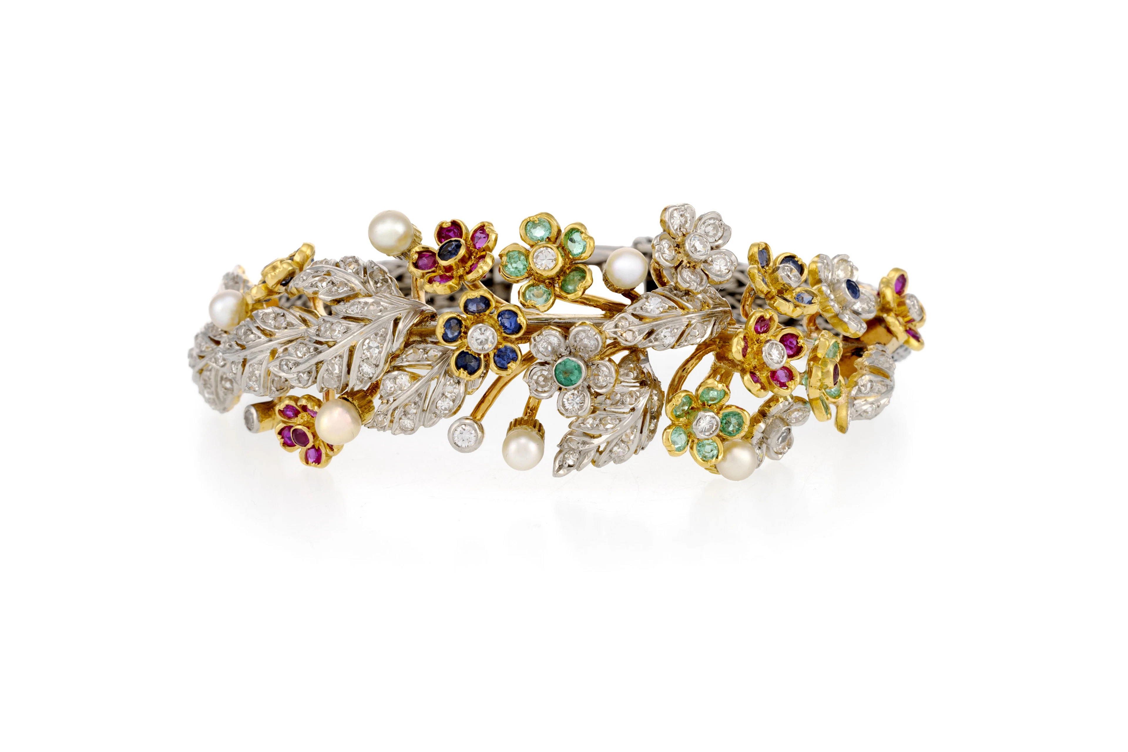 Bracelet semi rigide 2 ors 750 à décor végétal serti de saphirs, d'émeraudes
