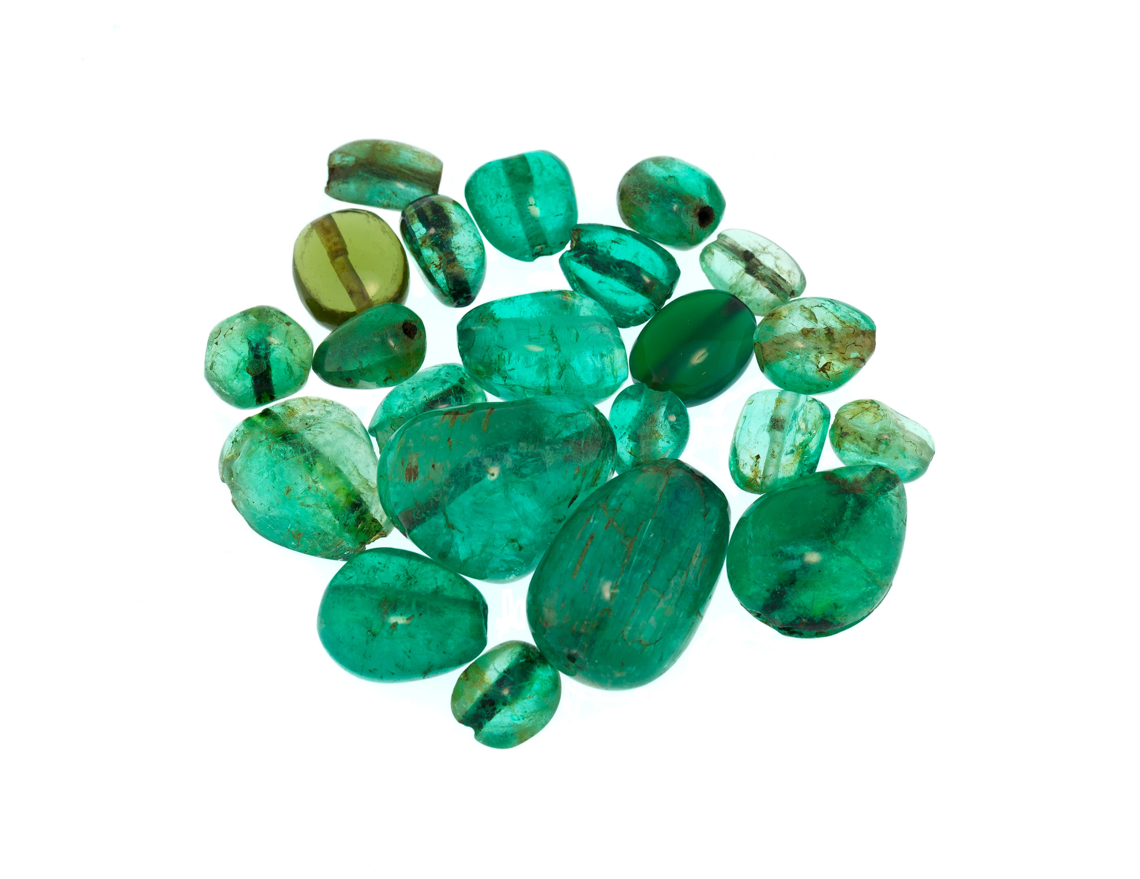 Lot d’émeraudes, d'un péridot et d'une chrysoprase percés sur papier