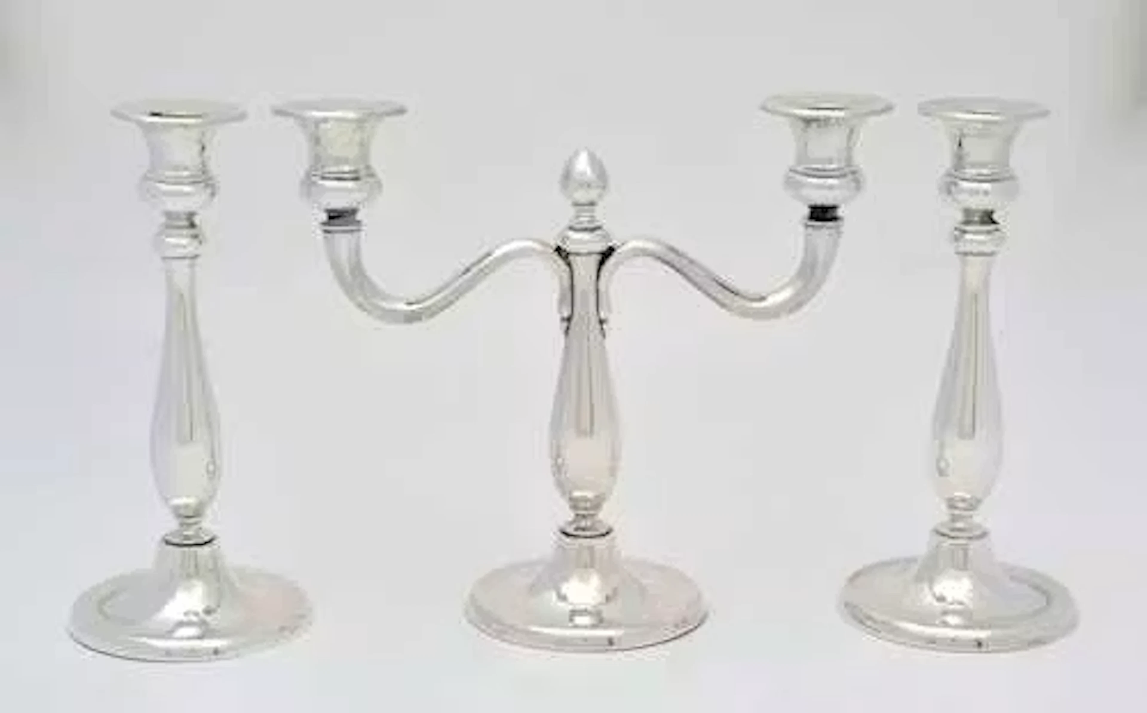 PAIR OF CANDLESTICKS AND A TWO-LIGHT CANDELABRUM