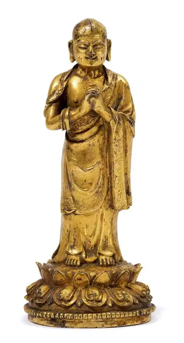 A GILT BRONZE FIGURE OF A BUDDHIST DISCIPLE