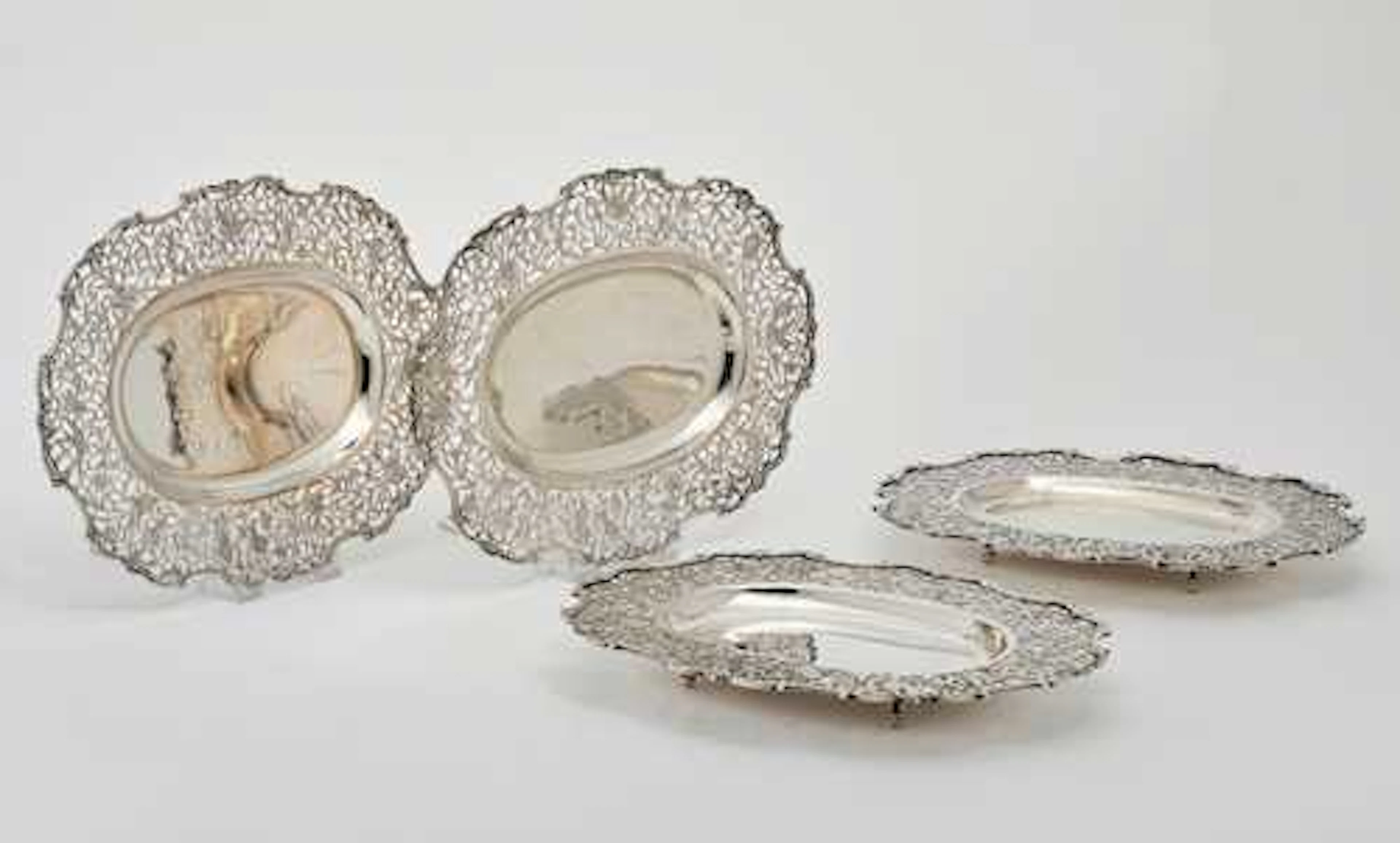 FOUR OVAL FOOTED BOWLS