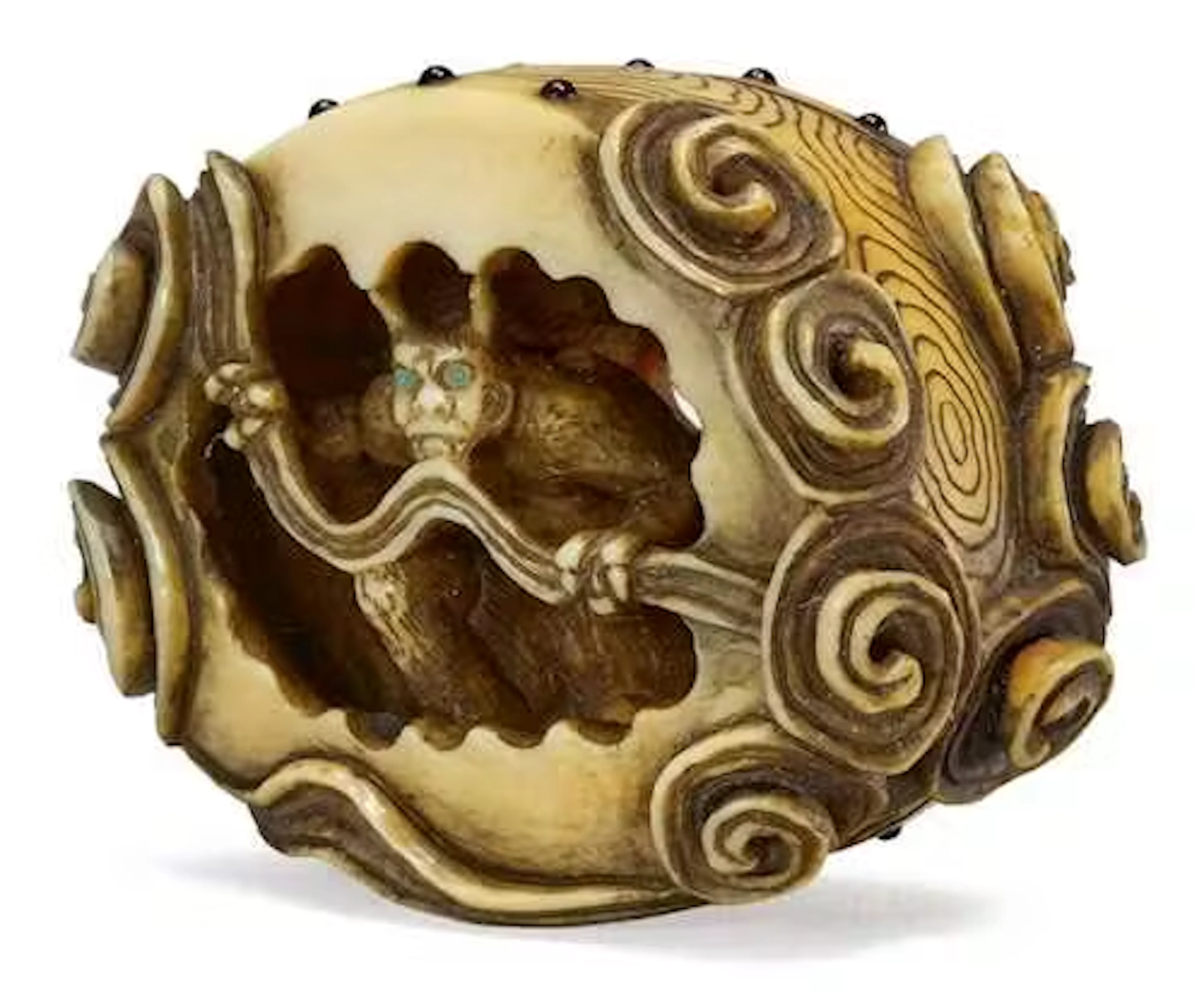A NETSUKE OF AN ONI INSIDE A DRUM